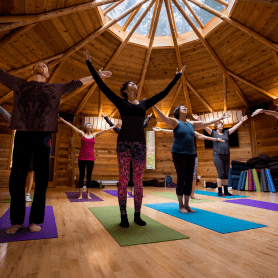 Group of people at Hollyhock Cortes Island Retreat Centre practicing yoga
