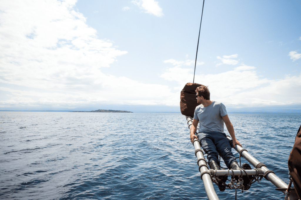 Man on a boat looking at the water and Hollyhock Retreat Centre