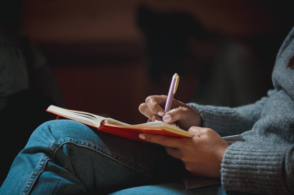 Person writing in a book
